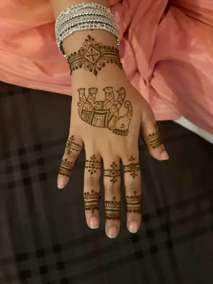 A fun and quirky design featuring a Hamsa hand, perfect for someone who wants a unique and symbolic mehndi.