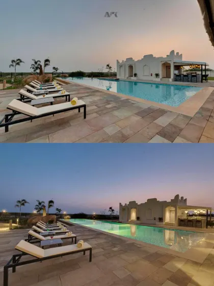 The poolside at The Fern Sattva Resort in Kutch, designed to be a tranquil escape. The architecture of the pool bar and the layout of the lounge areas are intended to harmonize with the resort's natural, earthy aesthetic.