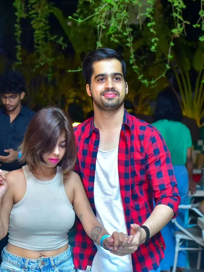 A focused and stylish pair, lost in the music.