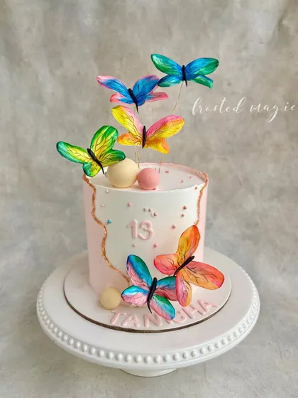 Another take on the butterfly theme, this time for a 13th birthday. The hand-painted wafer paper butterflies seem to fly off the cake, creating a light and airy design perfect for a teenager.