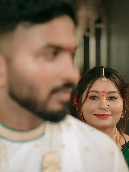 A creative shot with the bride in focus and the groom blurred in the foreground, symbolizing her looking towards her future with him.