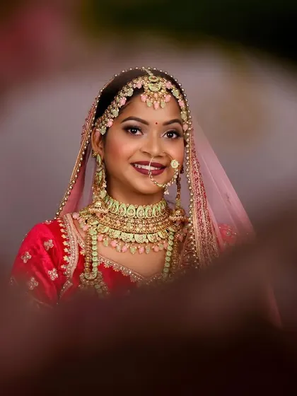 A beautiful close-up from a pre-bride shoot, designed as a trial run for the wedding day look. This portrait uses a creative framing technique to draw focus to the bride's happy expression and flawless makeup.