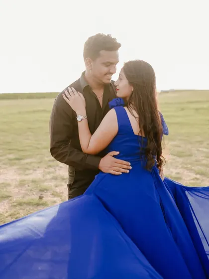 An intimate close-up of the couple. The vibrant blue of her gown contrasts wonderfully with his simple black shirt, making them the focus of the shot.