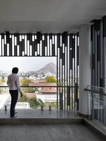 A view through the MS Jaali screens at the Sona University Centre in Salem. These screens provide shade and privacy while framing views of the surrounding landscape, demonstrating a modern interpretation of a traditional architectural element.