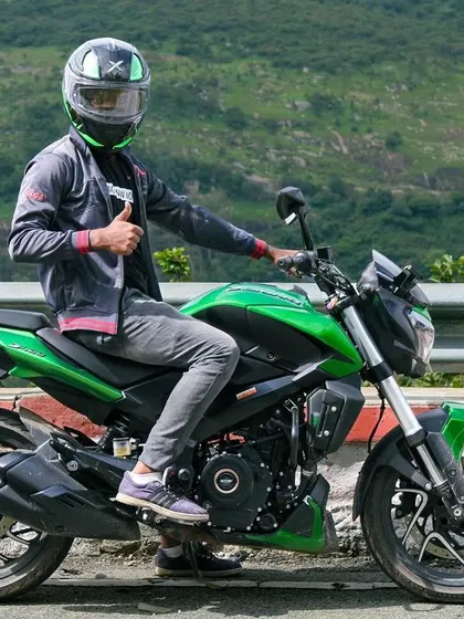 A rider giving a thumbs-up during a scenic Nandi Hills outing. We encourage all our members to join these fun and accessible rides.