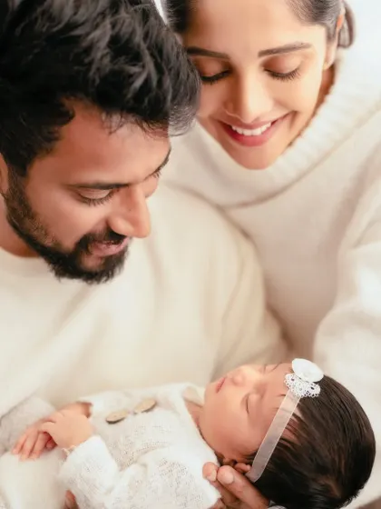 Proud parents gazing lovingly at their newborn baby. This image is all about the emotion and wonder of new parenthood.