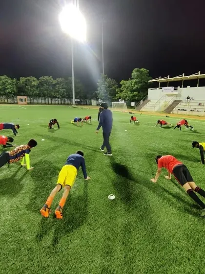 Players performing plank exercises in a circle, a key part of our core strength training program.
