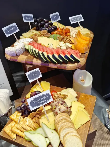 A selection of our finest cheeses on display, including Camembert, Gouda, and English Cheddar. Each cheese is labeled, allowing guests to explore different flavours at their leisure.