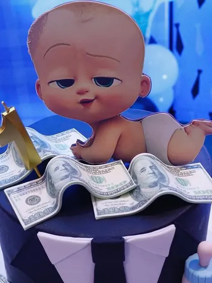The perfect cake for a Boss Baby theme. We can help arrange custom cakes like this one, featuring the Boss Baby character, a suit design, and edible money details to match the party decor.