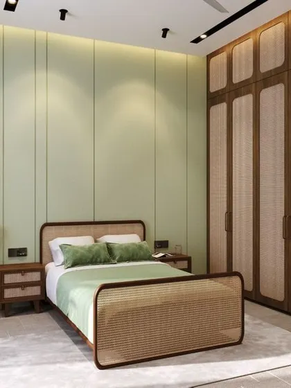 This minimal bedroom interior uses a soft, pastel green accent wall and natural cane furniture to create a fresh and calming atmosphere. The design focuses on clean lines and natural materials, proving that simplicity can be both classy and colorful.