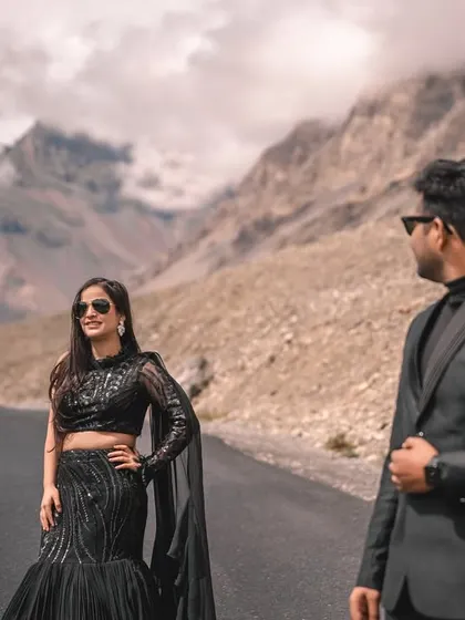 A stylish portrait on a mountain road in Spiti. I use the leading lines of the road and the texture of the mountains to create depth and focus on the couple's confident presence.