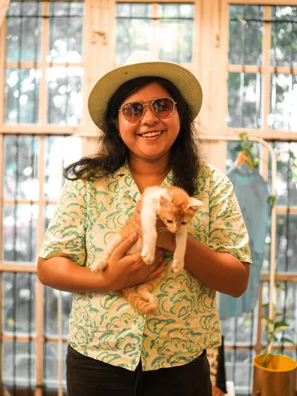 A participant holds a sweet ginger kitten, both looking happy and relaxed.