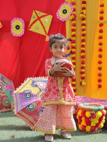 Dressed in beautiful ethnic wear, this little girl holds a traditional pot, soaking in the vibrant spirit of our Baisakhi festival celebration.