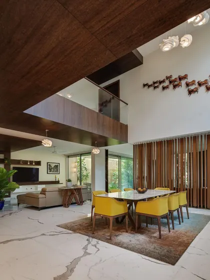 Another perspective of the double-height volume in Kanasu, emphasizing the scale and the way light and space are used to create a dramatic yet welcoming interior.
