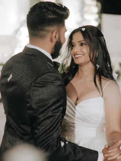 A beautiful, candid close-up of the bride smiling at her groom during their first dance.