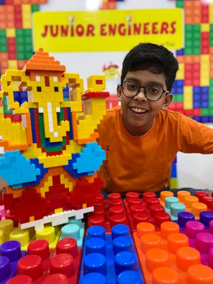 Creativity and culture come together in our special workshops. Here, a young engineer proudly displays his large, intricate Ganesha idol built entirely from LEGO bricks during our festive camp. We believe in making learning a memorable and joyful experience.