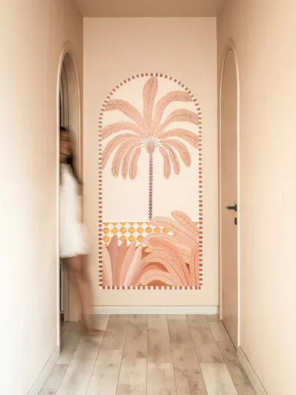 A hand-painted mural in the hallway adds a moment of artistic joy. We believe art should be a quiet companion that enhances the journey through a home.