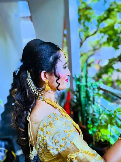 A side profile of the reception hairstyle, showing how the hair is swept back from the face. This style looks beautiful and is also comfortable for the bride to wear.