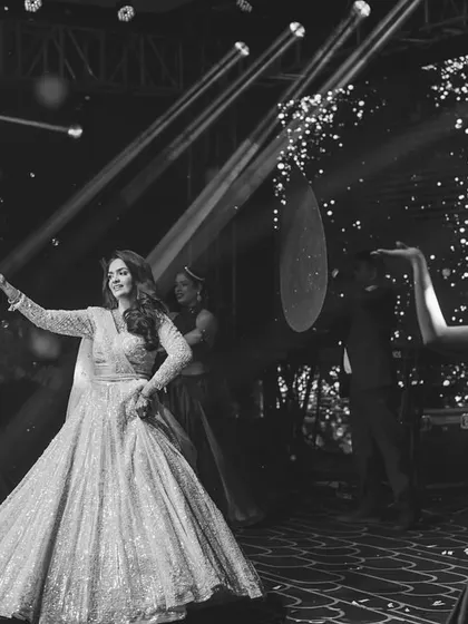 A classic black and white shot of a bride's performance. It captures the timeless elegance and grace of her solo dance.