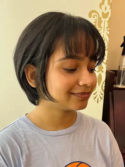A wispy, razor-cut bob with bangs for Medhavi. This technique creates a soft, textured finish.