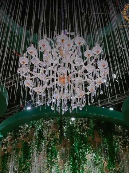 A detailed shot of one of the many crystal chandeliers, showcasing its intricate design and the way it refracts light to create a dazzling effect.