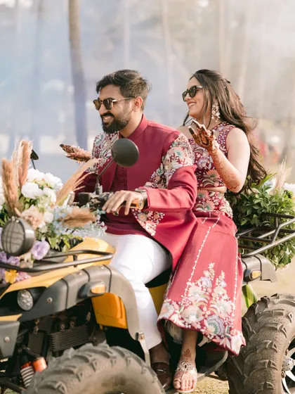 Making a grand entrance on an ATV. This shot is pure fun and adventure, perfectly showcasing the couple's playful side and the unique elements of their wedding carnival.