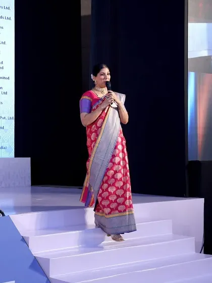 Walking across the stage during the MATEXIL awards, ensuring a dynamic and visually engaging presentation.