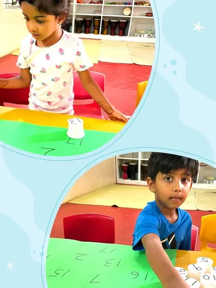 Two children are pictured enjoying a hands-on number matching game. We use simple, creative props to make learning concepts like number recognition feel like pure fun.