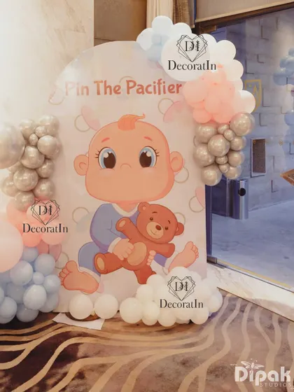 A "Pin the Pacifier" game board, adding a classic and fun activity to the shower.