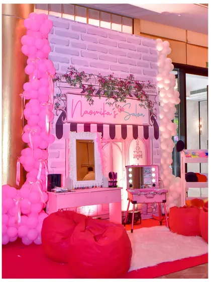 I set up 'Naomika's Salon' as a fun activity station for the Parisian party, complete with a vanity, mirrors, and bean bags for a pampering experience.
