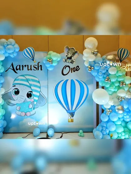 A cute baby elephant and hot air balloon themed party setup.