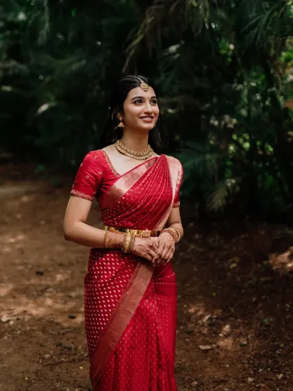 A full-length shot showing the beautiful drape of the saree and the overall elegant look for her engagement.