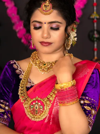 A portrait of the model, showcasing the intricate choker, jhumkas, and maang tikka.