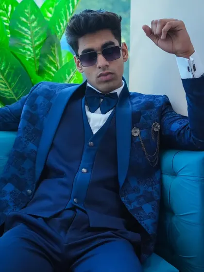 A model looking cool and confident in our royal blue patterned suit. It's a modern look for a stylish man.