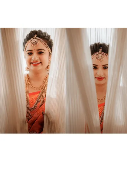 A playful portrait of a bride peeking through curtains, capturing her happy and slightly mischievous spirit on her wedding day.