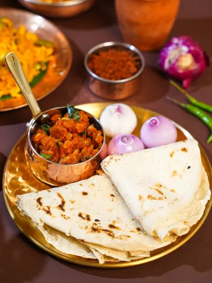 A simple, soulful Maharashtrian meal of thecha and bhakri. We styled this with whole onions and green chilies to represent the authentic, rustic way it's eaten in villages, celebrating the beauty of simplicity in food.