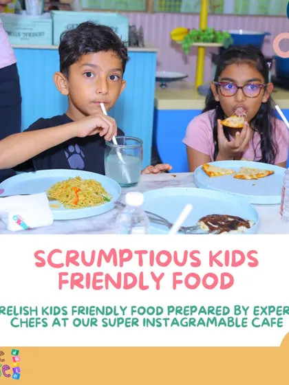 I provide scrumptious, kid-friendly food prepared by expert chefs at our super Instagrammable cafe. This picture shows kids enjoying a tasty meal of noodles and pizza.
