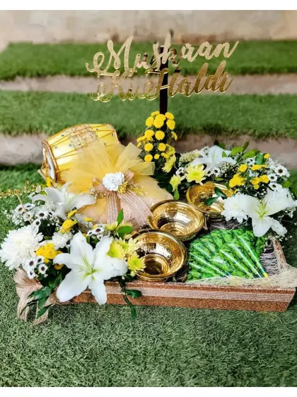 This customized Haldi Mehndi platter is bursting with the happy color of yellow. I used fresh white and yellow flowers, a decorative dholki, and hammered brass bowls to create a festive and functional piece for the ceremony.
