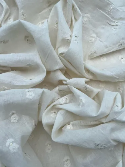 This off-white embroidered cotton with delicate floral butis and sequin highlights is a perfect example of natural beauty and timeless elegance.