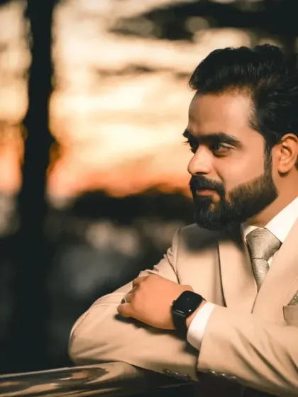The groom looking out thoughtfully against a beautiful sunset backdrop. This is a powerful, moody portrait that feels both timeless and modern.
