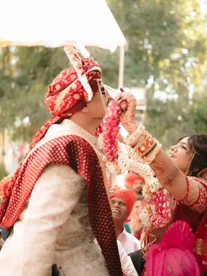 The Varmala exchange, a moment of joy and playful competition between the bride and groom.