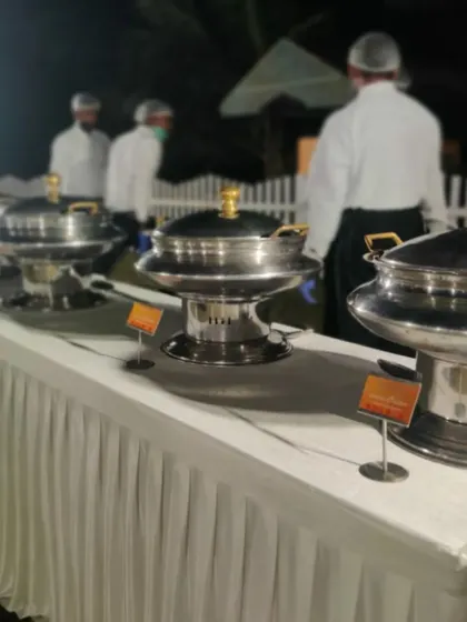 This is a glimpse of our catering setup for a wedding at the ASC centre. Our team stands ready behind the buffet to assist guests and ensure the food service is flawless.