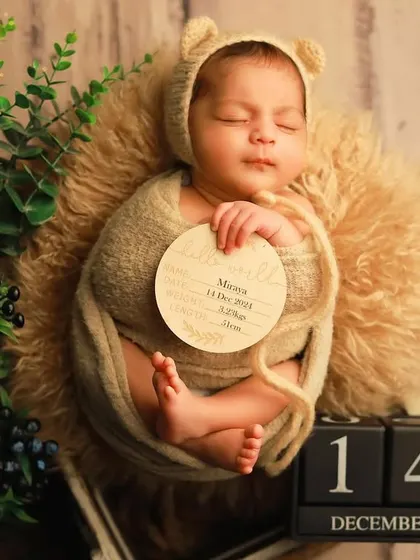 A personalized birth announcement photo for baby Miraya. We incorporate custom props like this wooden "hello world" sign and date blocks to create a unique keepsake that captures all the important details of her arrival.