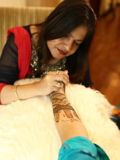 A candid shot of me completely focused on my craft. Applying mehendi is a meditative process that requires immense concentration and a steady hand.