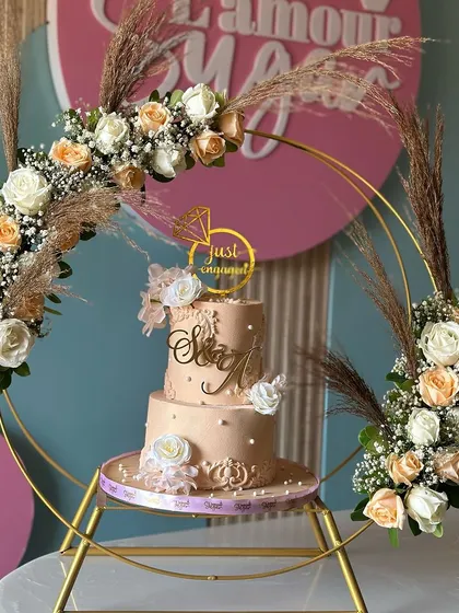 Soft, elegant, and timeless. This peach and white engagement cake, set within a beautiful floral hoop, combines graceful design with sweet simplicity, perfect for celebrating a new chapter.