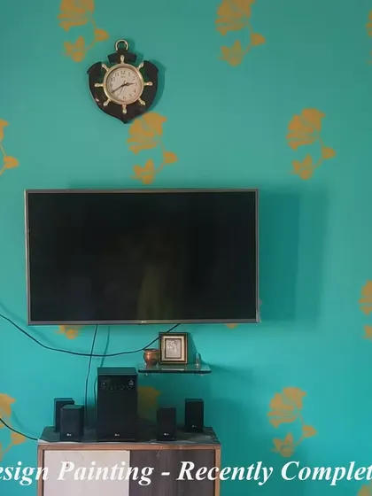 We completed this project featuring a floral stencil design in yellow over a teal accent wall. This combination of colors and pattern adds a fresh and stylish touch to the TV area.