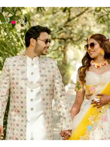 A sweet moment between our bride Rumani and her groom at their Haldi. Her custom floral jewellery perfectly matches the fun and festive atmosphere.