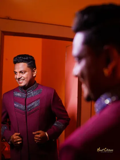 A candid shot of the groom smiling at his reflection. Capturing these moments of happy anticipation is part of the story.