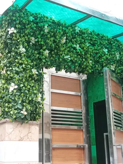 I love how this installation in Saket transformed the entrance of the house. The artificial green wall with white flowers wraps around the gate, creating a welcoming and lush first impression.