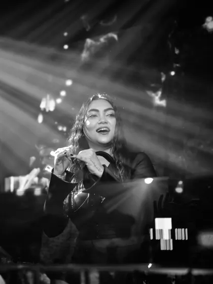 A candid black and white photo of me enjoying the moment, surrounded by light beams in the club.